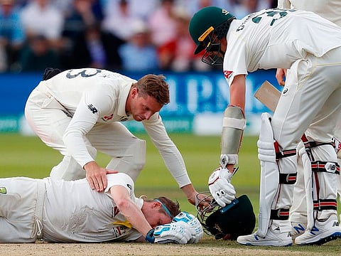 Australia's Steve Smith lays on the pitch after being hit in the neck by a ball off the bowling of England's Jofra Archer during play on the fourth day of the second Ashes Test match at Lord's Cricket Ground in London on August 17, 2019. 