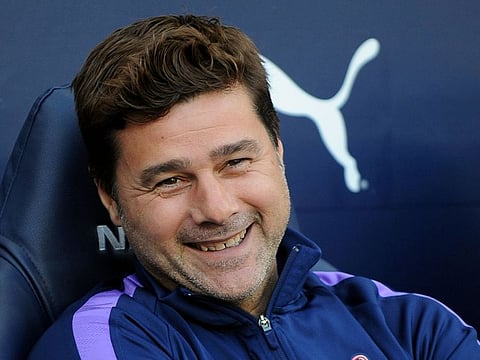 Tottenham's manager Mauricio Pochettino looks out from the bench prior the English Premier League soccer match against Manchester City at Etihad stadium in Manchester, on Saturday. 