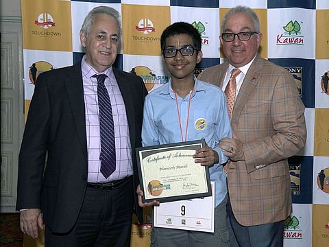 Navneeth Murali, centre, being given the certificate of achievement.