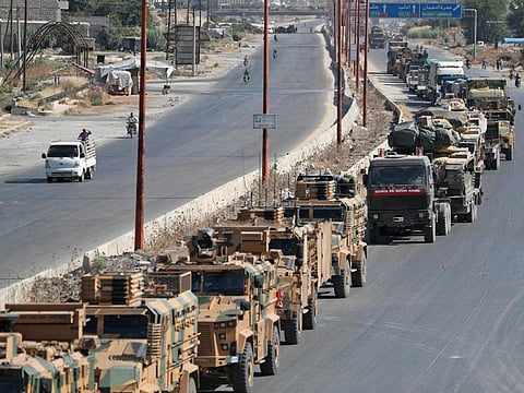A convoy of Turkish military vehicles passes through Maaret al-Numan in Syria's northern province of Idlib reportedly heading toward the town of Khan Sheikhun in the southern countryside of the province, on August 19, 2019.  
