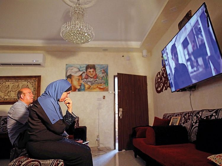 Reuters Hussein and Suha Abu Khdeir, whose son’s murder is the subject of the HBO series “Our Boys”, watch the show’s first two episodes in their East Jerusalem home August 18, 2019.