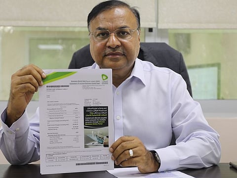Ashok Chaturvedi, who runs a medical training and events firm in Karama, displays his etisalat bill for June.