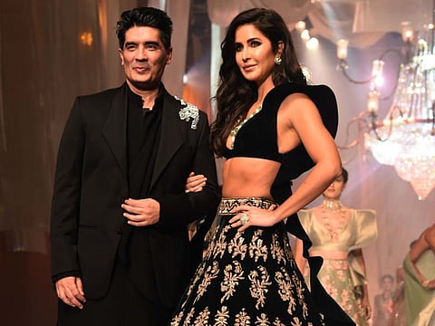 Designer Manish Malhotra (L) is accompanied by Bollywood actress Katrina Kaif as he greets the audience after presenting his creations at Lakme Fashion Week (LFW) Winter Festive 2019 in Mumbai on August 20, 2019.  - XGTY / RESTRICTED TO EDITORIAL USE
 / AFP / Sujit Jaiswal / XGTY / RESTRICTED TO EDITORIAL USE
