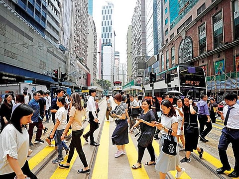 People cross a street in Hong Kong. Anything that erodes Hong Kong’s status as a global financial centre would also hurt Chinese companies.