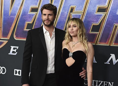 FILE - In this Monday, April 22, 2019, file photo, Liam Hemsworth, left, and Miley Cyrus arrive at the premiere of "Avengers: Endgame" at the Los Angeles Convention Center. Liam Hemsworth is seeking a divorce from Miley Cyrus after seven months of marriage. The 29-year-old Australian actor filed for the dissolution of his marriage to the 26-year-old American pop star in Los Angeles Superior Court on Wednesday, Aug. 21, 2019. (Photo by Jordan Strauss/Invision/AP, File)