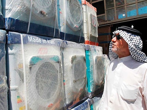 A customer looks at an Iranian-made washing machine at a store in Baghdad.