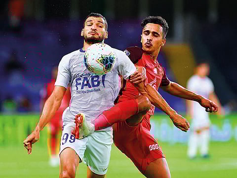 Fight for possession during the Arabian Gulf Cup match between Al Ain and Shabab Al Ahli Dubai.
