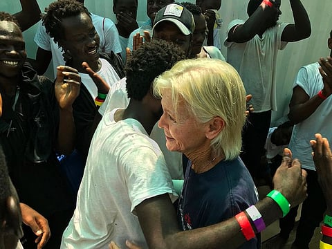 US nurse Maryjo (R) embraces 'Omar' as they are reunited aboard the 'Ocean Viking' rescue ship.