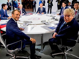 France's President Emmanuel Macron (L) and US President Donald Trump attend  a working session on "International Economy and Trade, and International Security Agenda" in Biarritz, south-west France, on the second day of the annual G7 Summit attended by the leaders of the world's seven richest democracies, Britain, Canada, France, Germany, Italy, Japan and the United States. File photo taken on August 25, 2019