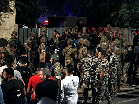 Lebanese security stand at the site where an Israeli drone was said to have crashed in a stronghold of the Lebanese Hezbollah group, in a southern suburb of Beirut, Lebanon, Sunday, Aug. 25, 2019. A Hezbollah official said Sunday that an Israeli drone went down over the Lebanese capital of Beirut and another exploded in the air, amid regional tensions between Israel and Iran.