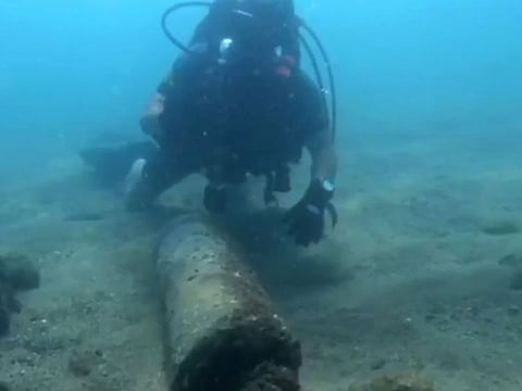 A diver checking a bomb, dating back to Spain's 1936-9 civil war, and containing 70 kilos (150 pounds) of trinitrotoluene, a "highly volatile" substance, found 25 meters from the shore in Barcelona. 
