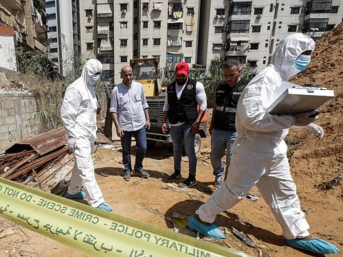 This picture taken on August 25, 2019 shows forensic investigators of Lebanon's military intelligence inspecting the scene where two drones came down in the vicinity of a media centre of the Shiite Hezbollah movement earlier in the day. 