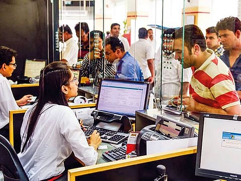 Indian expatriates queue up at UAE Exchange in Rolla Square, Sharjah. The trade war between the US and China, and concerns over Indian economy growth rates are driving the rupee down.