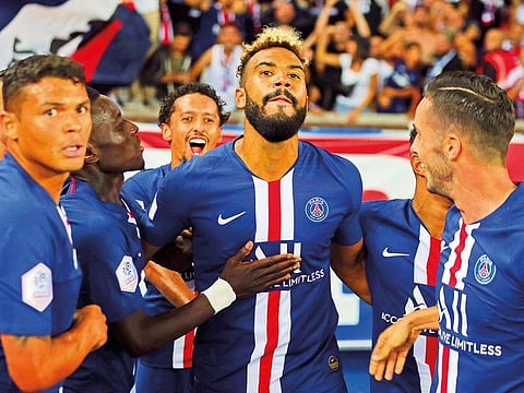 PSG’s Eric Maxim Choupo-Moting (centre) celebrates with teammates after scoring his side’s first goal during their match against Toulouse Sunday. PSG won 4-0.