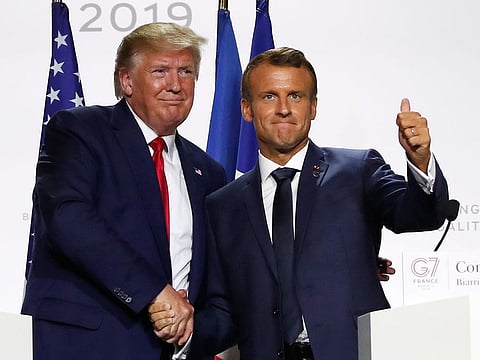 US President Donald Trump and French President Emmanuel Macron shake hands after their joint press conference at the G7 summit on Monday, in Biarritz, southwestern France.  