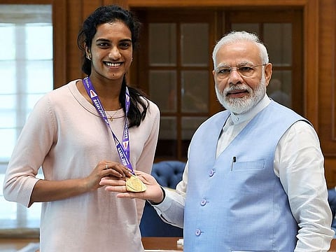 Indian Prime Minister Narendra Modi meets with P.V. Sindhu in New Delhi, days after she won gold at the BWF Badminton World Championships. 
