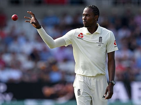 England's Jofra Archer collects the ball as he goes back to ball on the third day of the third Ashes cricket Test match between England and Australia at Headingley in Leeds, northern England.