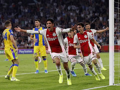 Ajax's Mexican forward Edson Alvarez (front) celebrates after scoring.