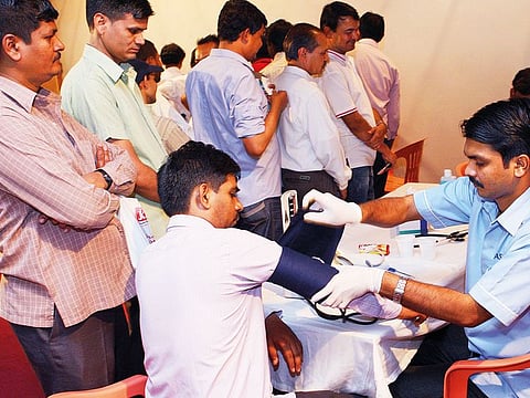 Workers getting themselves examined at a free health camp at Indian Consulate in Dubai 