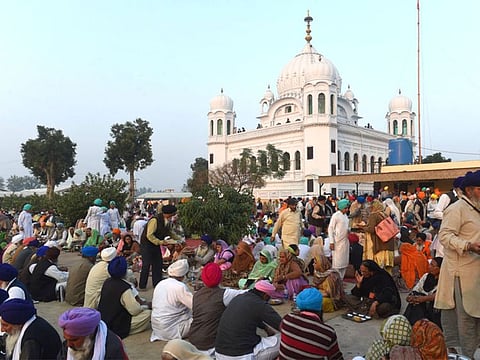 Sikh Pilgrims eat food in front of Kartarpur Gurdwara Sahib after a groundbreaking ceremony for the Kartarpur Corridor in Kartarpur on November 28, 2018. Pakistan Prime Minister Imran Khan launched the groundbreaking ceremony of the religious corridor between India and Pakistan.