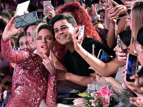 US actress Kristen Stewart takes a selfie as she arrives for the premiere of 'Seberg' during the 76th annual Venice International Film Festival, in Venice, Italy, 30 August 2019.