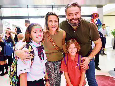 Cem Vildiz, along with his wife Cansu Vildiz see off their children Derin (left) and Poyraz on their first day at school in GEMS Dubai American Academy at Al Barsha, Dubai.