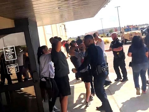 In this image taken from a social media video, people are evacuated from an Odessa theater following a mass shooting Saturday. 