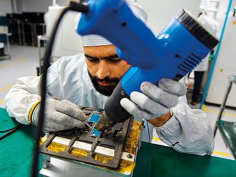 An employee works at a factory owned by Indian phone manufacturer Lava in Noida. Foreign orders increased at their slowest pace in 16 months a manufacturing survey shows.