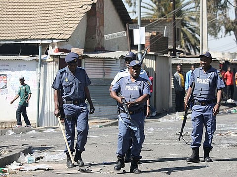 Police patrol the streets after overnight unrest and looting in Alexandra township, Johannesburg, South Africa