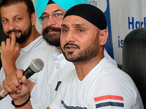 Indian cricketer Harbhajan Singh (C) speaks with media persons during an event at Amandeep Cricket Ground in Amritsar on August 21, 2019.