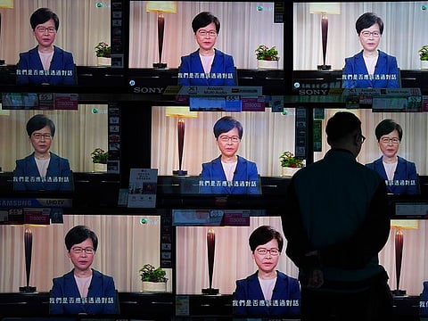 A man watches the television message that Hong Kong Chief Executive Carrie Lam makes an announcement on the extradition bill, at a home electronics retailer in Hong Kong.