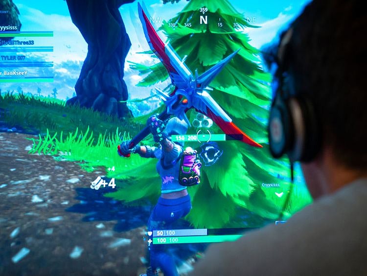 NAT STOCK  Teenager playing Fortnite video game1-1567602179082