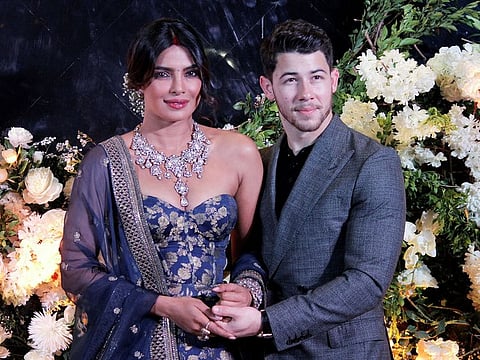 Bollywood actress Priyanka Chopra and her husband singer Nick Jonas pose during a photo opportunity at their wedding reception in Mumbai, India December 19, 2018.