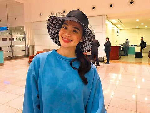 Anne Curtis arriving at Dubai airport early yesterday morning. Right: A still from her movie ‘Just A Stranger’ with Marco Gumabao.
