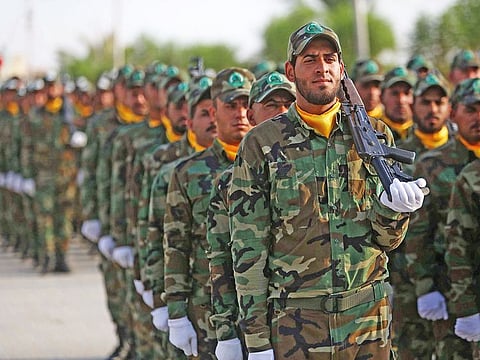 Members of the ‘Liwa Al Tafuf’ 13th Brigade of Iraq’s Shiite Hashed Al Shaabi (Popular Mobilisation units) paramilitary take part in a graduation ceremony at a training centre in the central Iraqi city of Karbala on August 30.