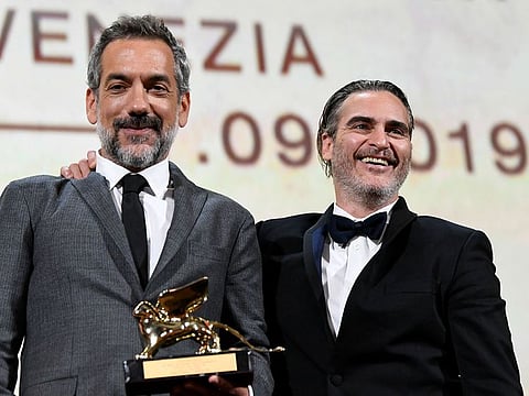 Director Todd Phillips poses next to Joaquin Phoenix after winning the Golden Lion for Best Film.