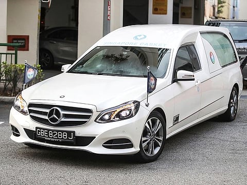 A hearse carrying the body of former Zimbabwe President Robert Mugabe leaves the Singapore Casket Funeral Parlour for the airport in Singapore Wednesday, Sept. 11, 2019.
