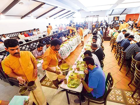 People enjoy Onasadhya, the traditional Onam feast, at Salkara Restaurant in Dubai. Hundreds of thousands of residents sat down to enjoy a vegetarian feast across the UAE.