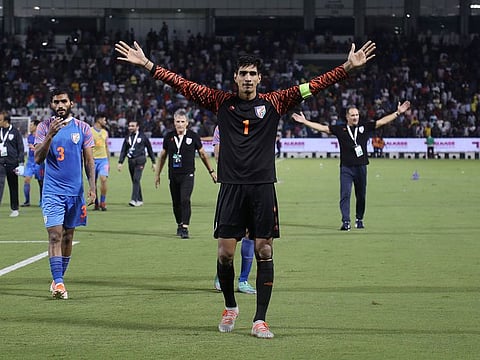 India's Gurpreet Singh Sandhu hails the fans after the 0-0 draw with Qatar.