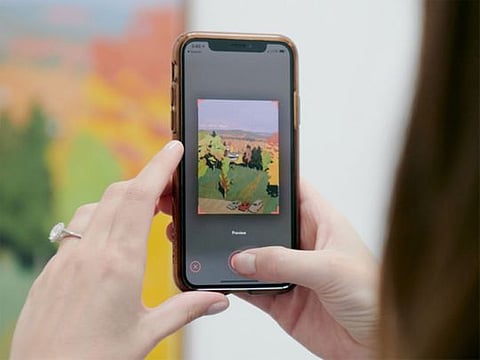 Jelena Cohen uses the Magnus app on her iPhone to scan paintings at the Parrish Art Museum in Water Mill, N.Y.