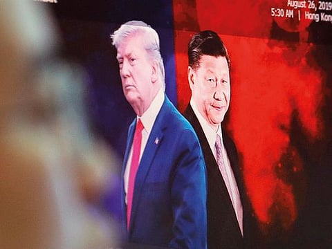 Images of Chinese President Xi Jinping and US President Donald Trump at a foreign exchange dealing room in Seoul. Hopes are growing that the two sides might defuse the prolonged dispute.