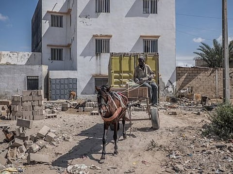 Wague Diouf and his horse, Toyota, drive through neighborhoods picking up trash in Dakar, Senegal, Aug. 14, 2019. The city’s horse-drawn buggies, long a staple means of getting around, are under an emerging threat from motorized rickshaws — city officials see the carts as a vestige of a poorer country, incompatible with the modern highways in a capital that is booming economically. (Yagazie Emezi/The New York Times)