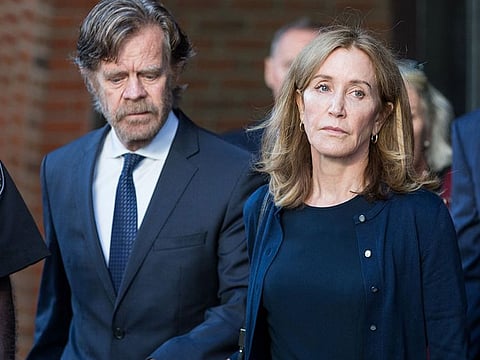 The actress Felicity Huffman leaves federal court beside her husband, the actor William Macy, after her sentencing in Boston, on Friday, Sept. 13, 2019.