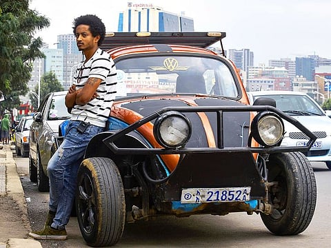 Ethiopian painter Robel Wolde, 25, poses in front of his pimped Volkswagen Beetle in Addis Ababa.