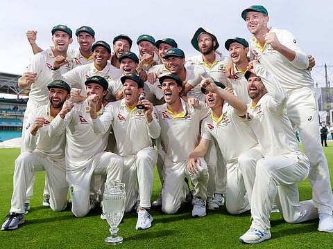 Australian cricket team poses with the Ashes urn at The Oval after they retained the honours in September. 