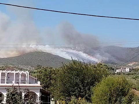 Smoke rises from the side of a hill due to a wildfire on the island of Zakynthos, Greece September 15, 2019. in this picture obtained from social media video.