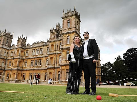 Visitors attend a 1920's themed event at Highclere Castle, near Newbury, west of London, on September 7, 2019, ahead of the world premiere of the Downton Abbey film. Highclere Castle is the main set location of the British television series Downton Abbey, which has been turned into a film, and will premiere on September 9 in London. / AFP / Isabel INFANTES
