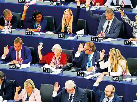 Brexit Party leader Nigel Farage, left middle row, and other members of parliament vote  on a resolution for Britain’s withdrawal from the European Union, in Strasbourg.