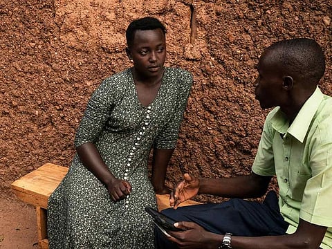  In this Sept. 10, 2019 photo, Janvier Ngabonziza, right, interviews Lyiza Uwimbabazi about her sister who passed away recently during a "verbal autopsy" in Rwamagana, Rwanda. 