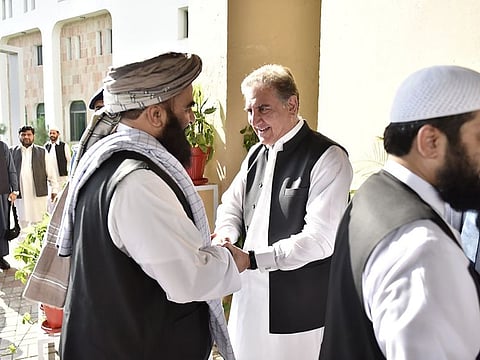 In this photo released by the Foreign Office, Pakistan’s Foreign Minister Shah Mahmoud Qureshi (centre) receives members of the Taliban delegation on Thursday.